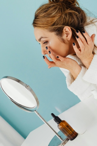 Applying ayurvedic herbal skincare product on face - keya ayurveda